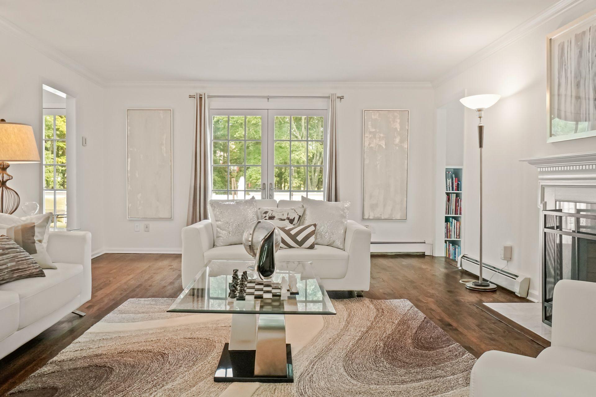 231 Ponus Ridge Road New Canaan, CT 06840 - Photo 10 of 37 a living room with furniture and a large window