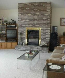 653 West Florence Road Freeport, IL 61032 - Photo 4 of 9 a living room with furniture a flat screen tv and a fireplace