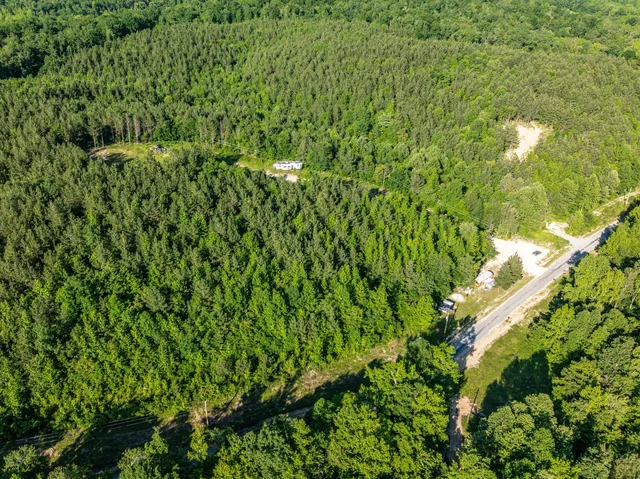 a view of a backyard with wooden fence