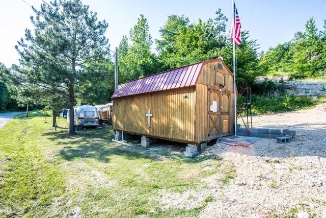 a front view of a house with garden and parking space