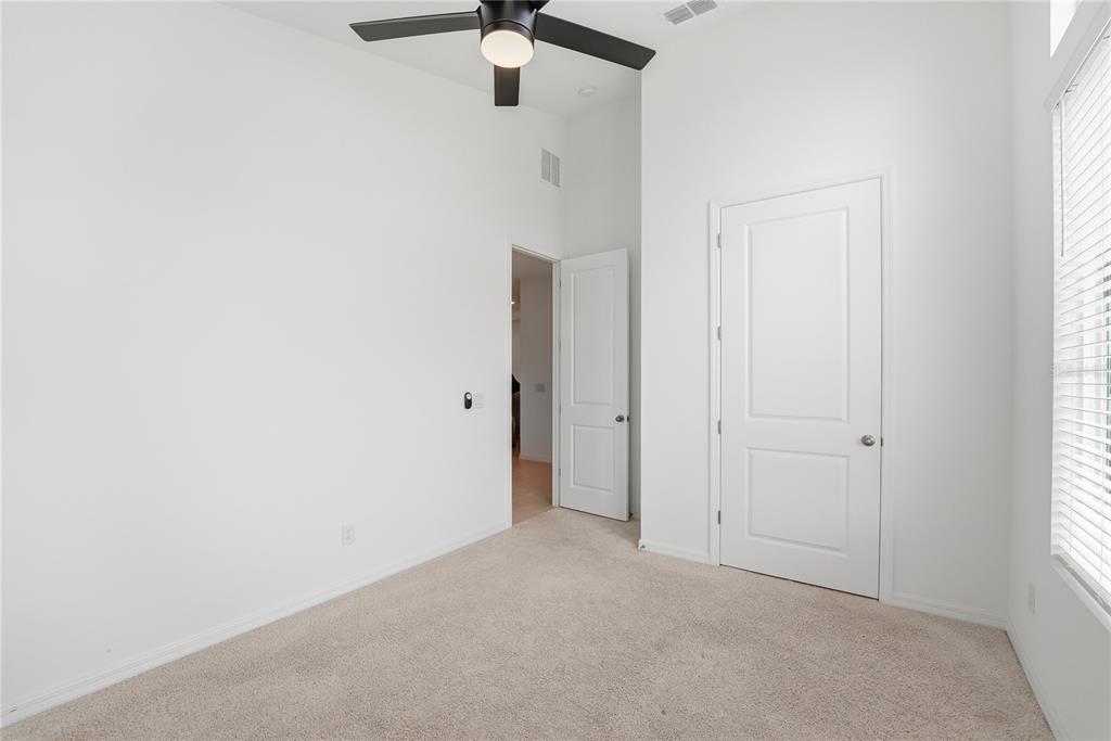 6550 Barnstorm Way St. Cloud, FL 34771 - Photo 11 of 35 an empty room with a window and a ceiling fan