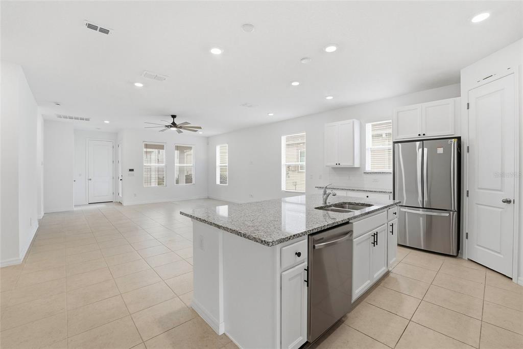 6550 Barnstorm Way St. Cloud, FL 34771 - Photo 13 of 35 a kitchen with a sink stove and refrigerator