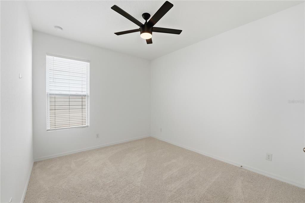 6550 Barnstorm Way St. Cloud, FL 34771 - Photo 25 of 35 an empty room with a window and a ceiling fan