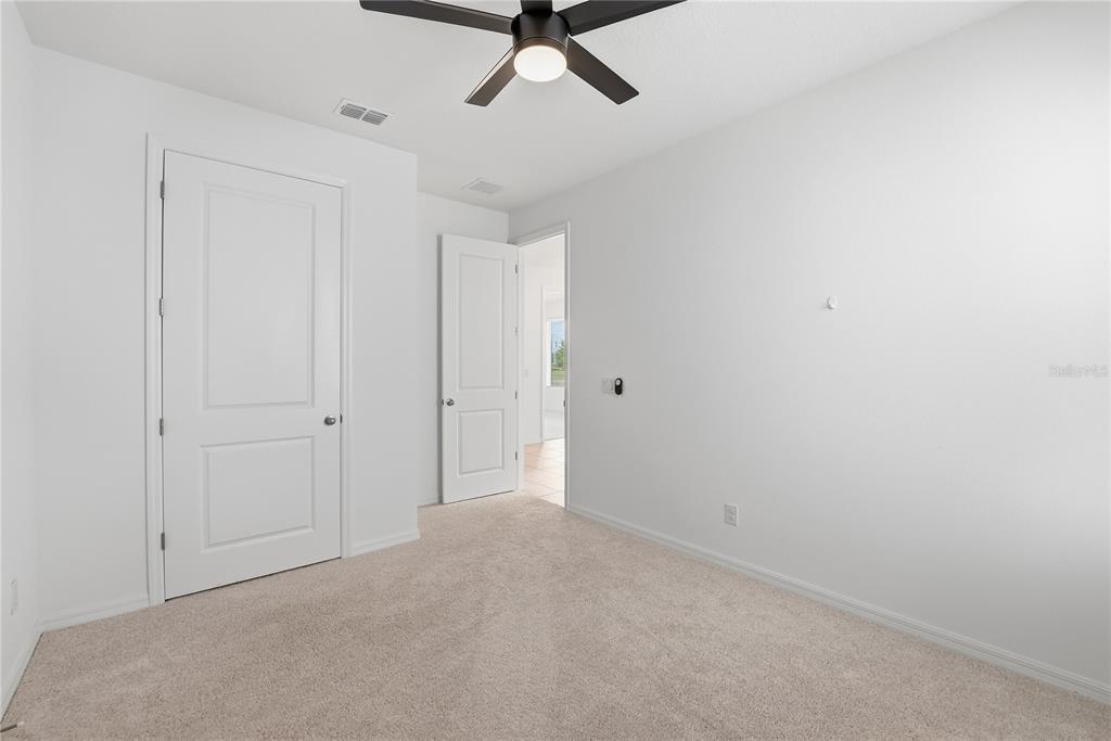 6550 Barnstorm Way St. Cloud, FL 34771 - Photo 26 of 35 a view of a livingroom with a ceiling fan & windows