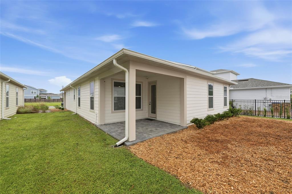 6550 Barnstorm Way St. Cloud, FL 34771 - Photo 31 of 35 a front view of house with yard and green space