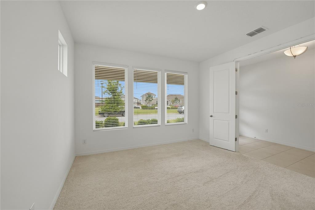 6550 Barnstorm Way St. Cloud, FL 34771 - Photo 9 of 35 an empty room with a empty space and windows