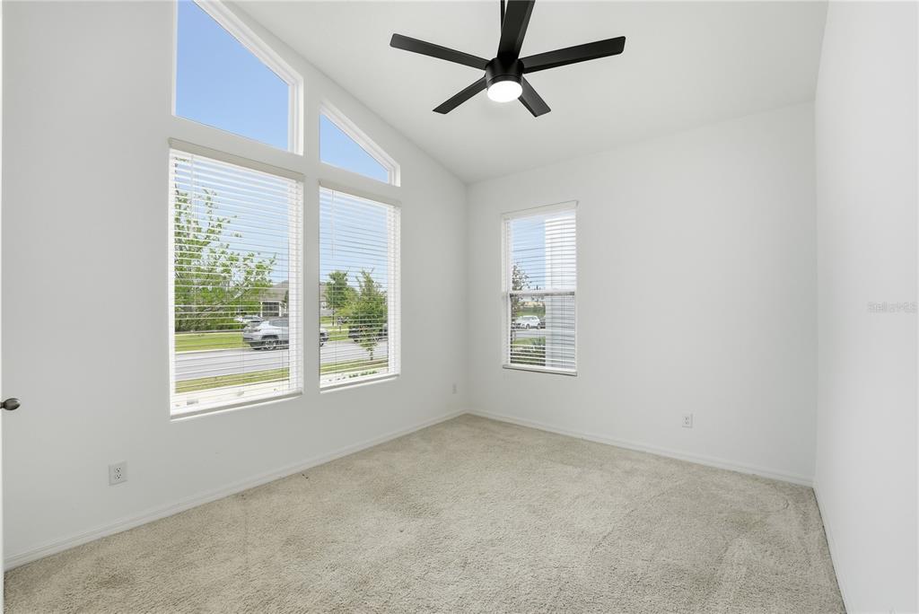 6550 Barnstorm Way St. Cloud, FL 34771 - Photo 10 of 35 an empty room with a window and a ceiling fan