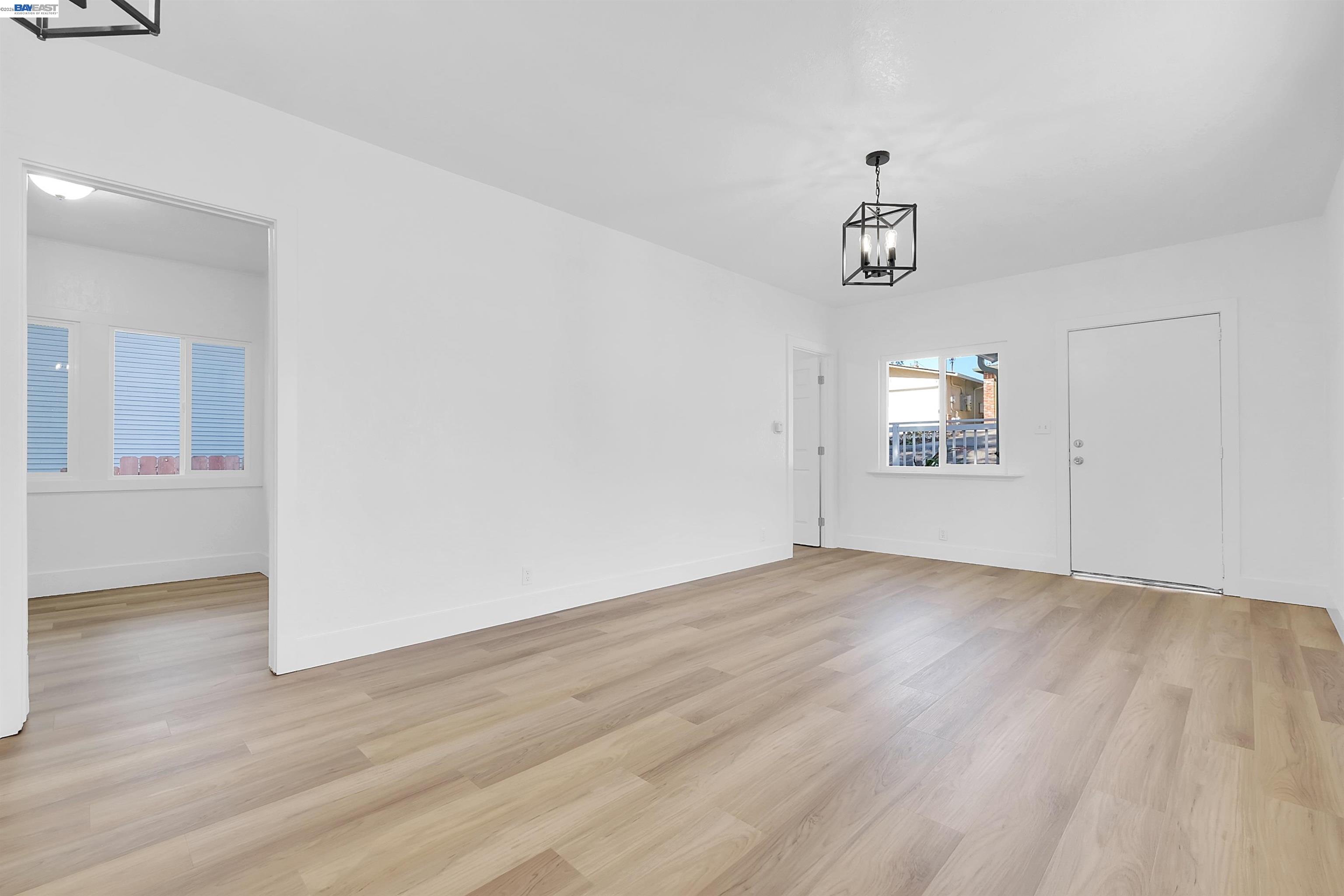 1467 Clay Street Hayward, CA 94541 - Photo 14 of 28 an empty room with wooden floor cabinet and windows