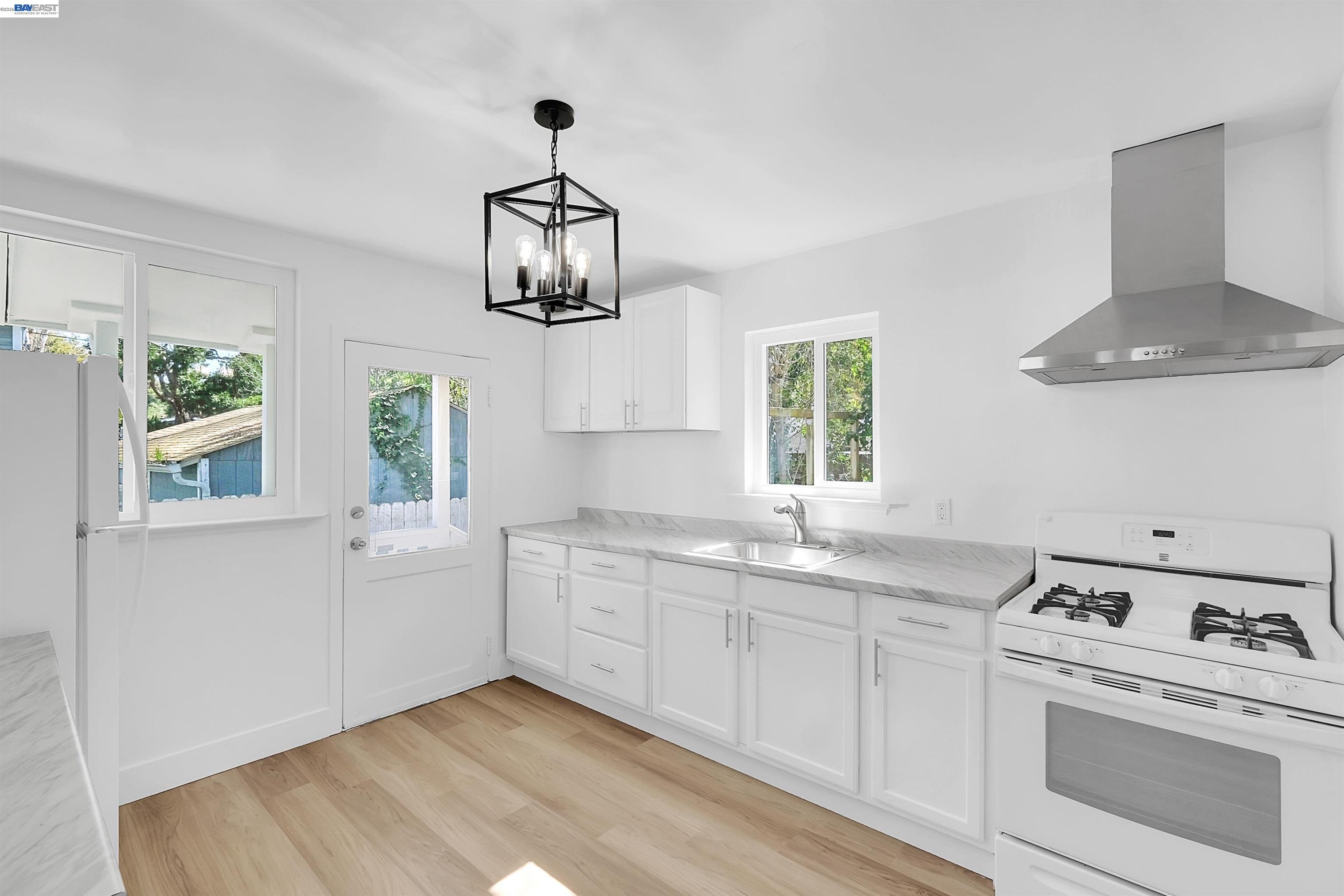 1467 Clay Street Hayward, CA 94541 - Photo 2 of 28 a kitchen with white cabinets and window