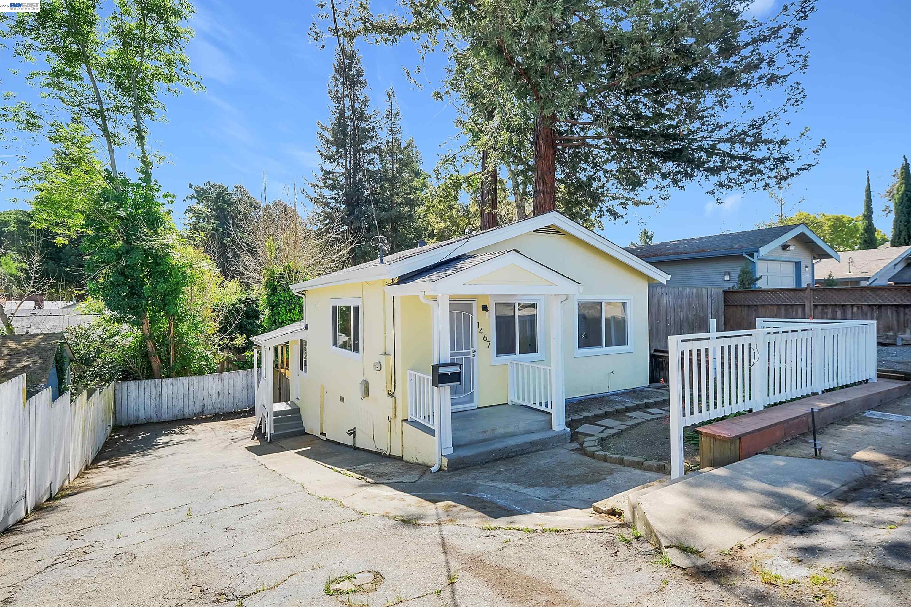 1467 Clay Street Hayward, CA 94541 - Photo 28 of 28 a view of a white house wooden fence and trees