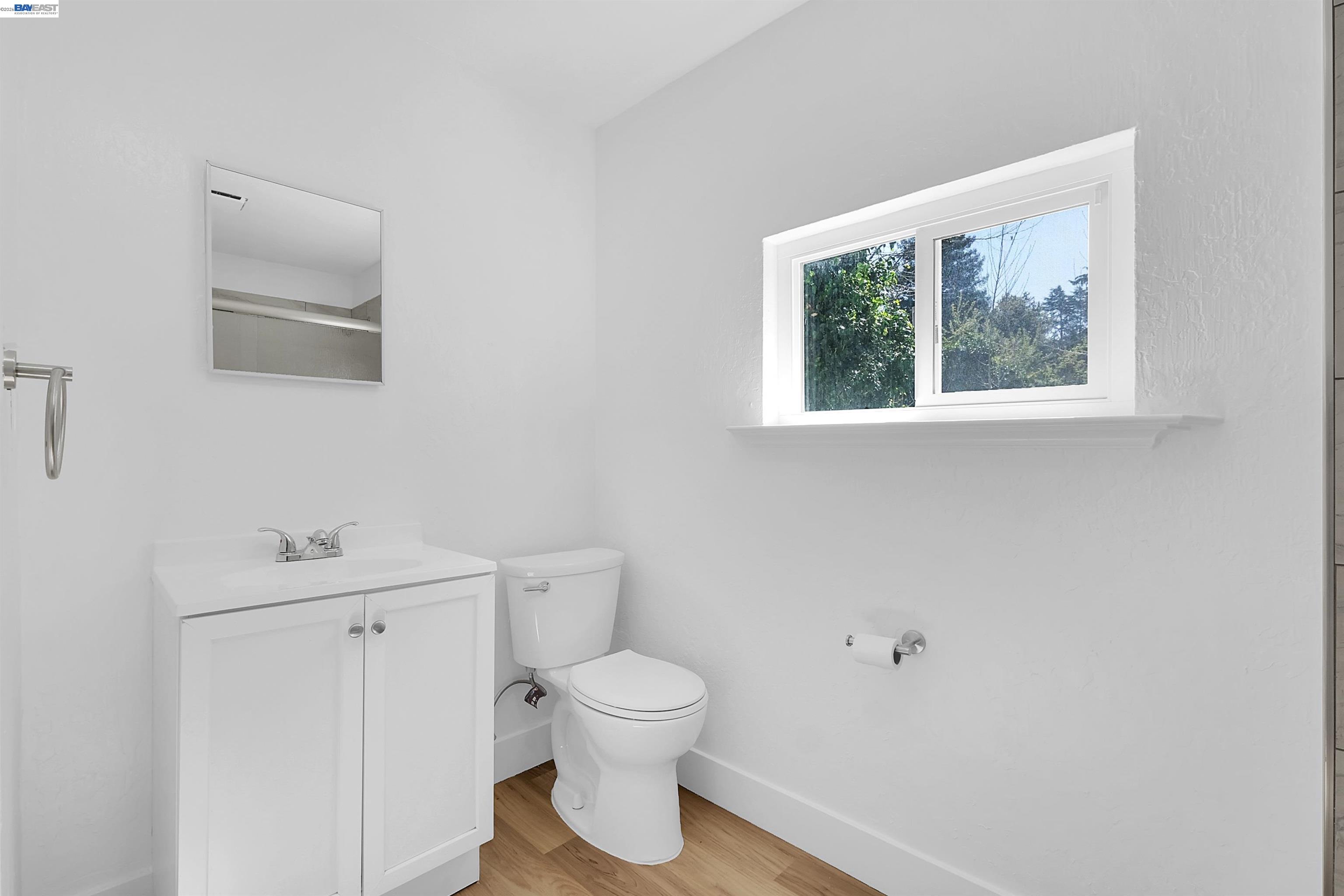 1467 Clay Street Hayward, CA 94541 - Photo 7 of 28 a bathroom with a toilet sink and mirror