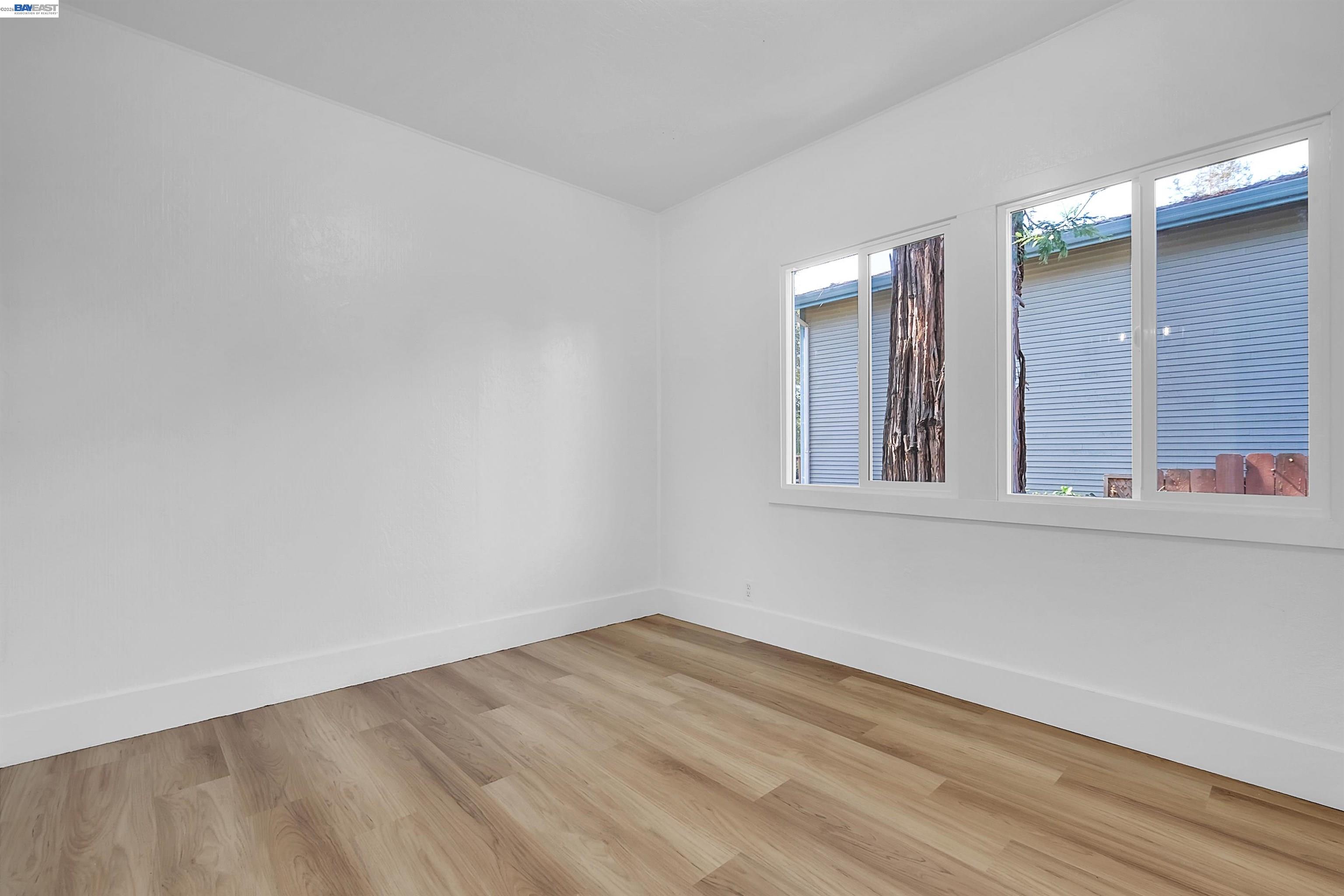 1467 Clay Street Hayward, CA 94541 - Photo 8 of 28 a view of an empty room with wooden floor and a window