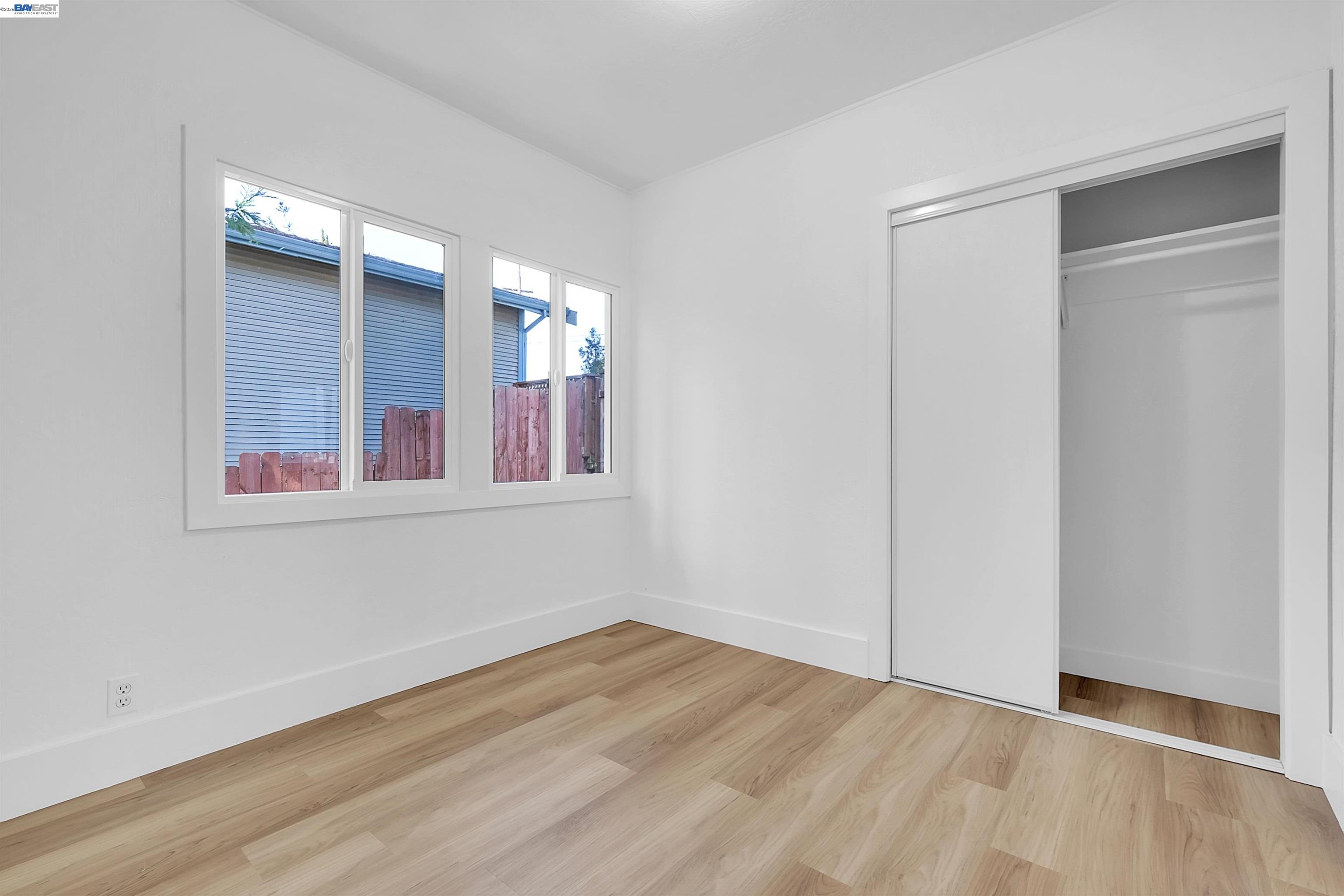1467 Clay Street Hayward, CA 94541 - Photo 10 of 28 a view of an empty room with wooden floor and a window