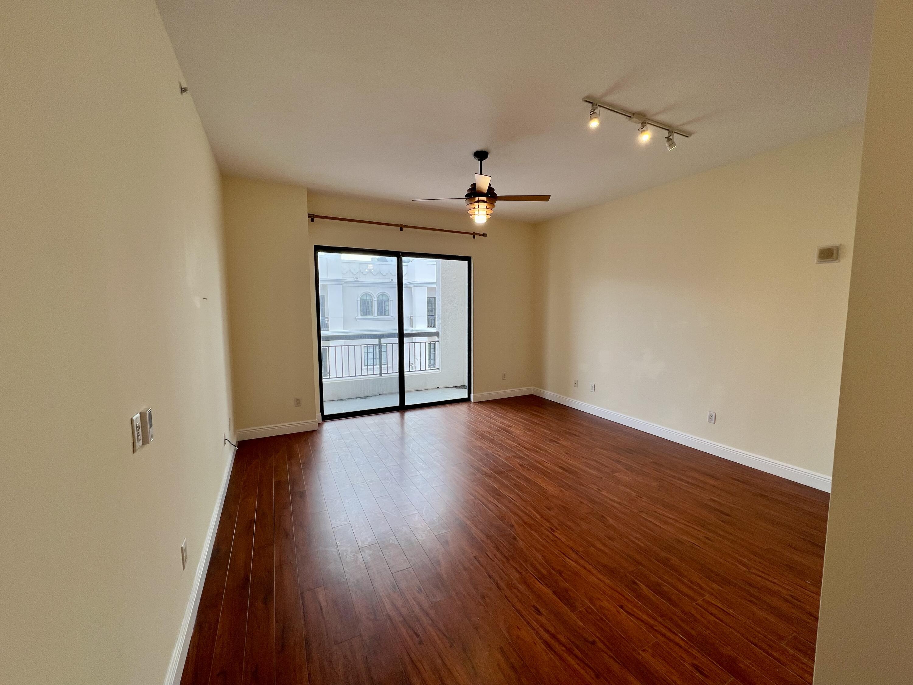 233 South Federal Highway, Unit UPH04 Boca Raton, FL 33432 - Photo 5 of 26 wooden floor in an empty room with a window