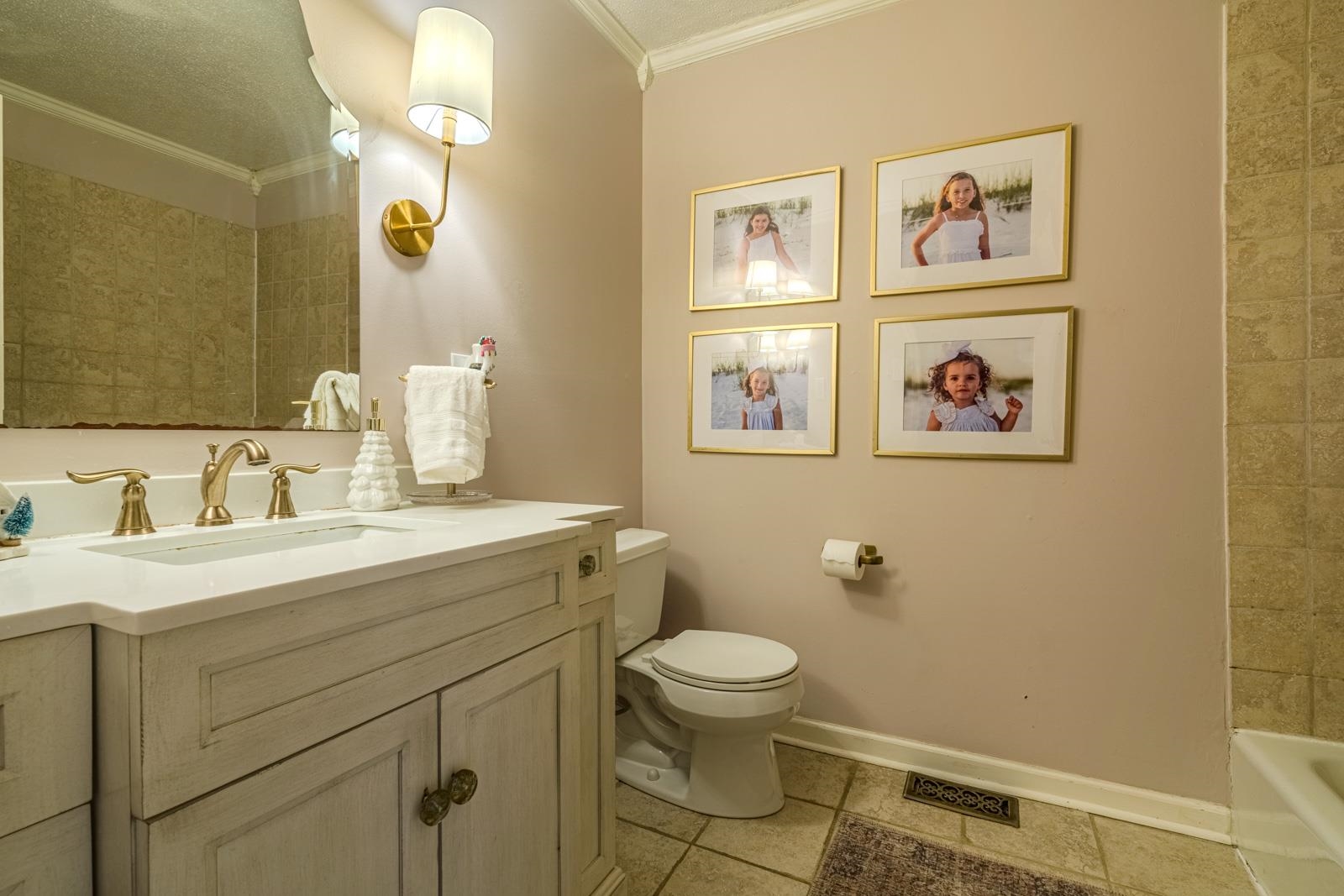 704 Irene Circle Covington, TN 38019 - Photo 21 of 31 a bathroom with a toilet sink and mirror