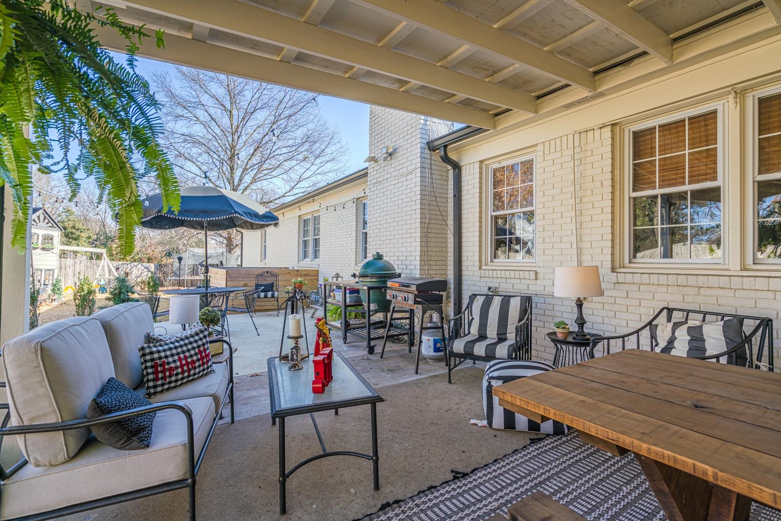 704 Irene Circle Covington, TN 38019 - Photo 23 of 31 a view of a patio with table and chairs couches with wooden floor and fence