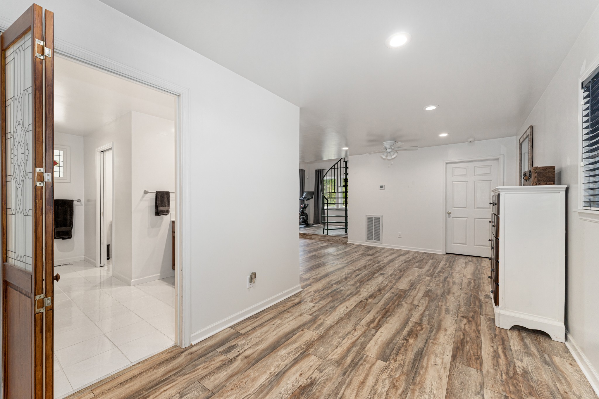 5704 Cane Ridge Road Antioch, TN 37013 - Photo 19 of 50 a view of a hallway with wooden floor and a refrigerator