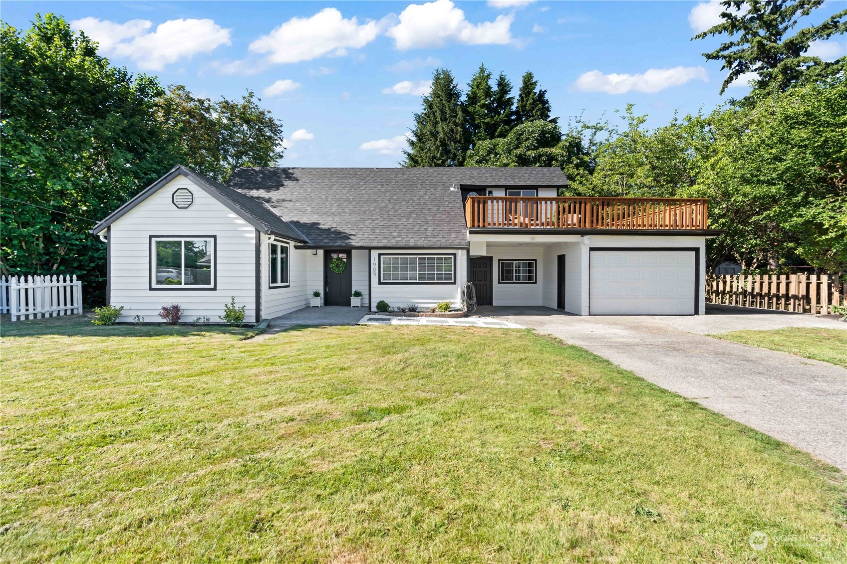 1909 Gary Street Sumner, WA 98390 - Photo 1 of 39 a front view of a house with a garden