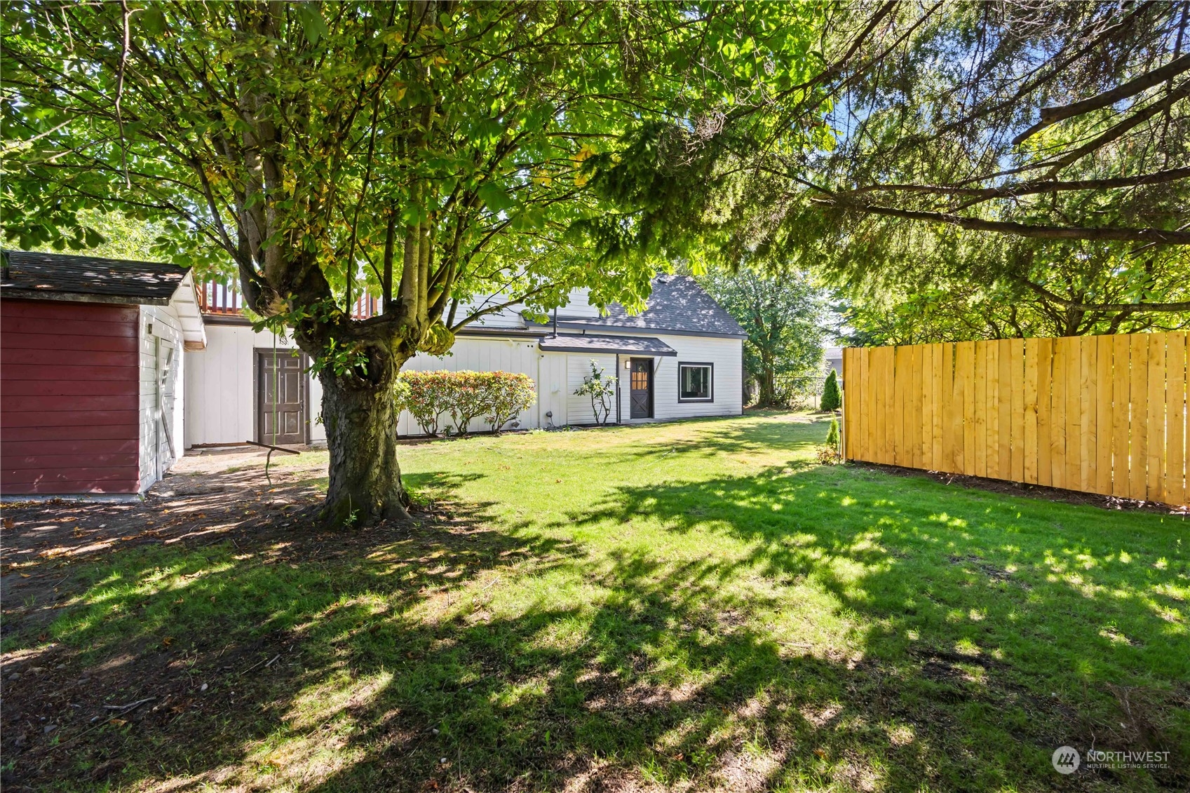 1909 Gary Street Sumner, WA 98390 - Photo 28 of 39 a house with a tree in the grass