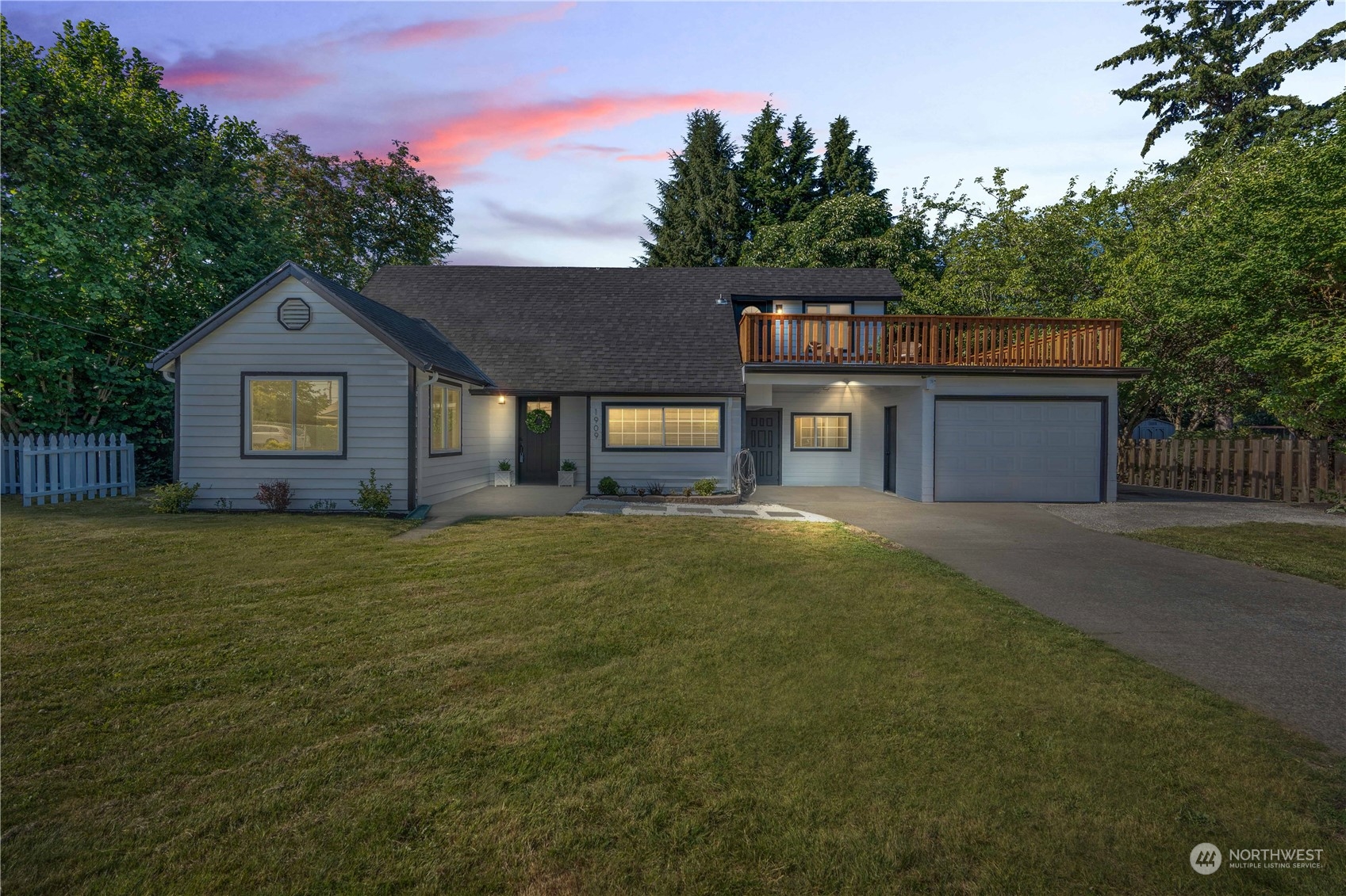 1909 Gary Street Sumner, WA 98390 - Photo 3 of 39 a front view of a house with a garden and tree