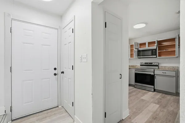 a view of empty room with wooden floor and ceiling fan