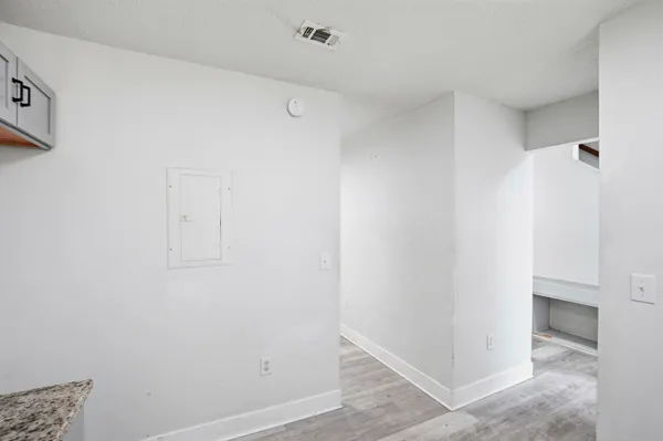a bathroom with a granite countertop toilet a sink and shower