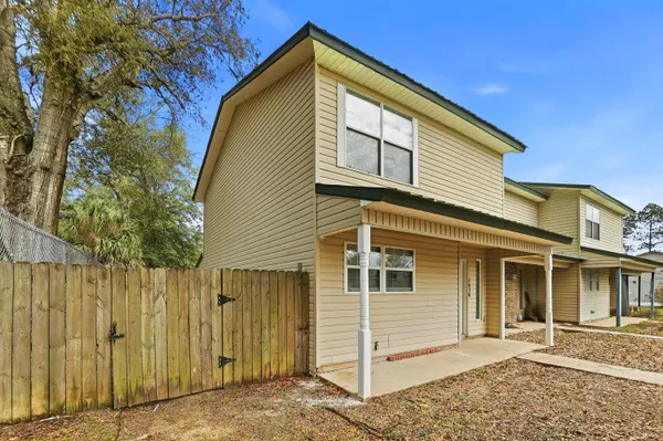 a view of an empty room and a window with wooden floor