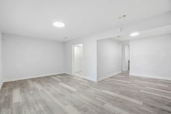 a kitchen with granite countertop a sink stainless steel appliances and white cabinets