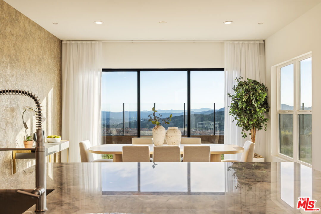 20668 Hummingbird Court Porter Ranch, CA 91326 - Photo 16 of 70 a living room with furniture large windows a rug and a chandelier