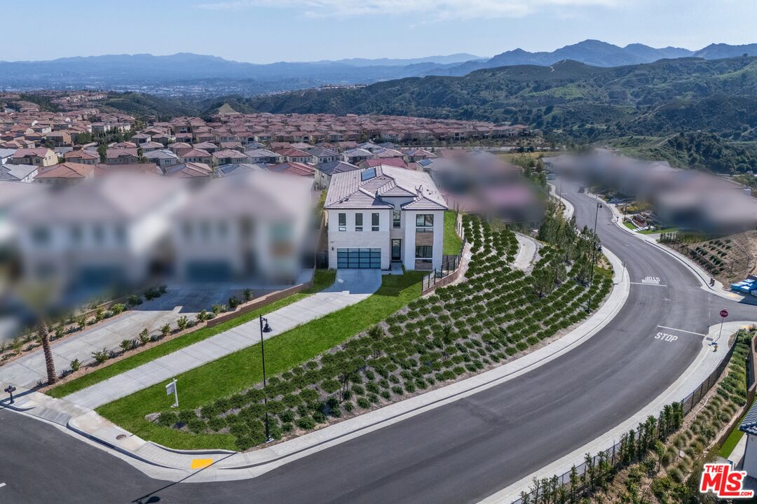 20668 Hummingbird Court Porter Ranch, CA 91326 - Photo 3 of 70 a view of a swimming pool with a yard and lake view