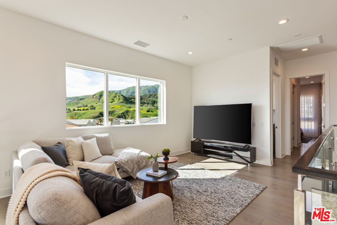 20668 Hummingbird Court Porter Ranch, CA 91326 - Photo 32 of 70 a living room with furniture and a flat screen tv