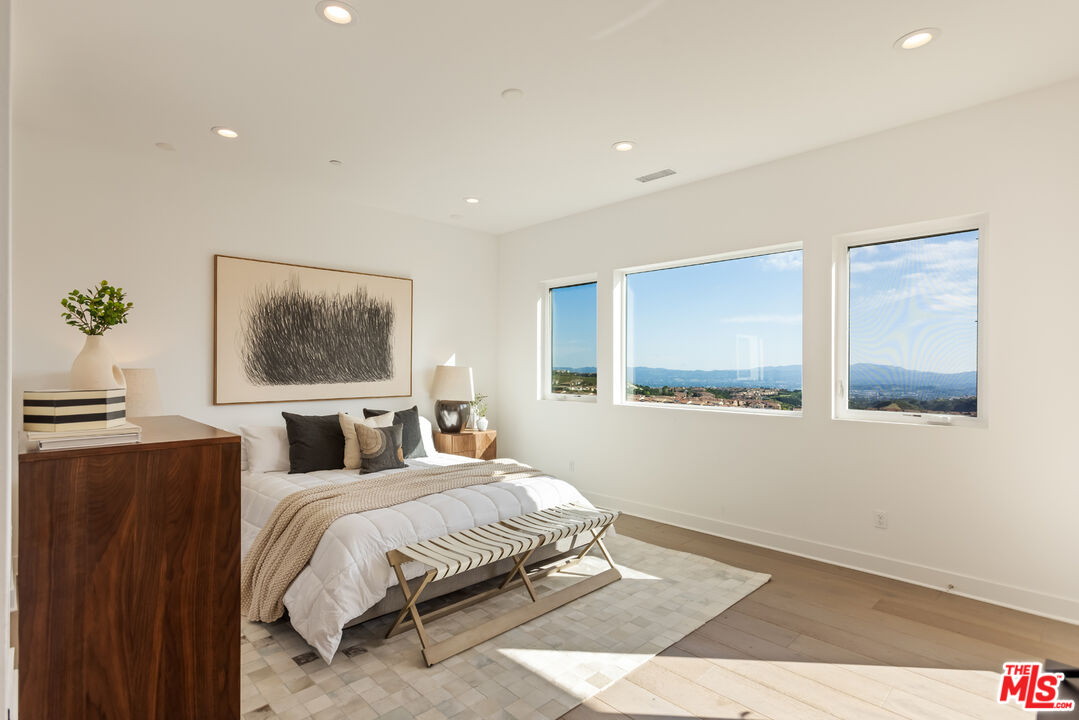 20668 Hummingbird Court Porter Ranch, CA 91326 - Photo 33 of 70 a bedroom with a large bed and a window