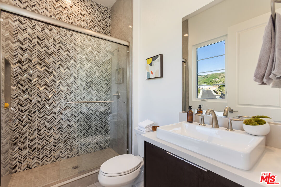 20668 Hummingbird Court Porter Ranch, CA 91326 - Photo 45 of 70 a bathroom with a sink toilet and shower