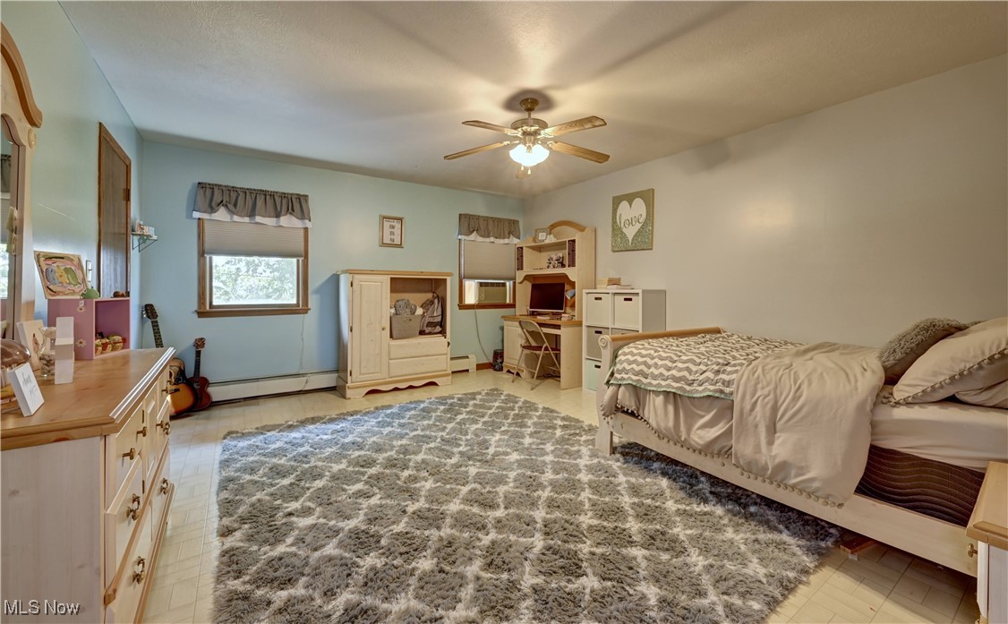 17198 Harrison Road Navarre, OH 44662 - Photo 36 of 45 Bedroom with an office area and baseboard heating