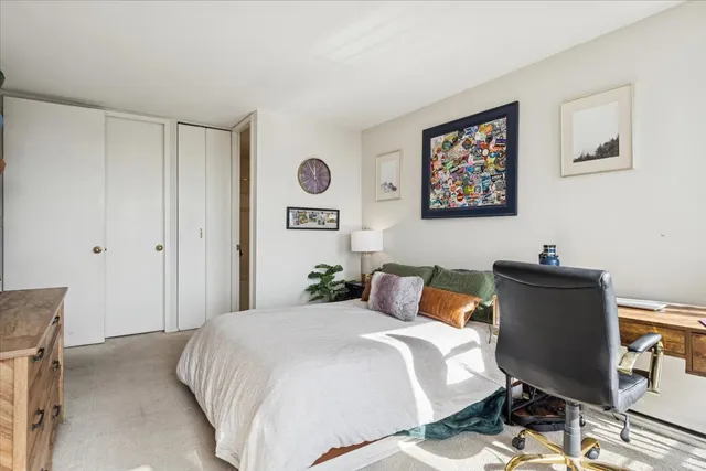 a bedroom with a bed and chair