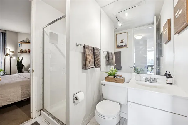 a bathroom with a sink mirror vanity and toilet