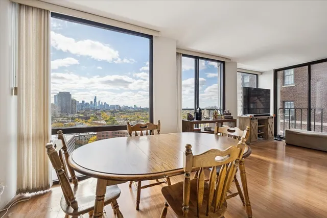 a dining room with furniture window and wooden floor