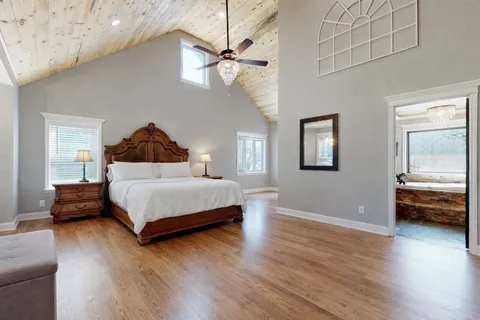 a bedroom with a bed and a chandelier