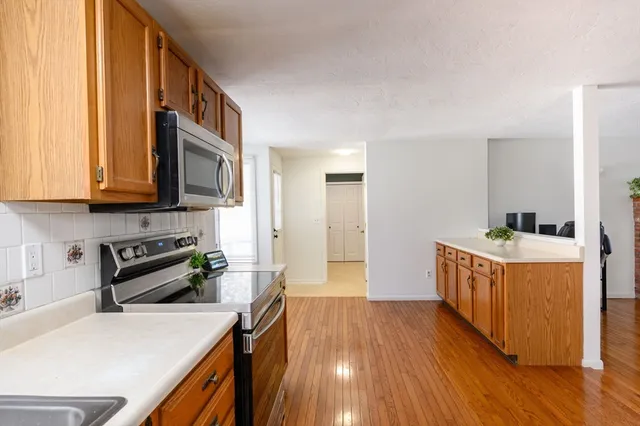 a kitchen with a stove a sink and a microwave