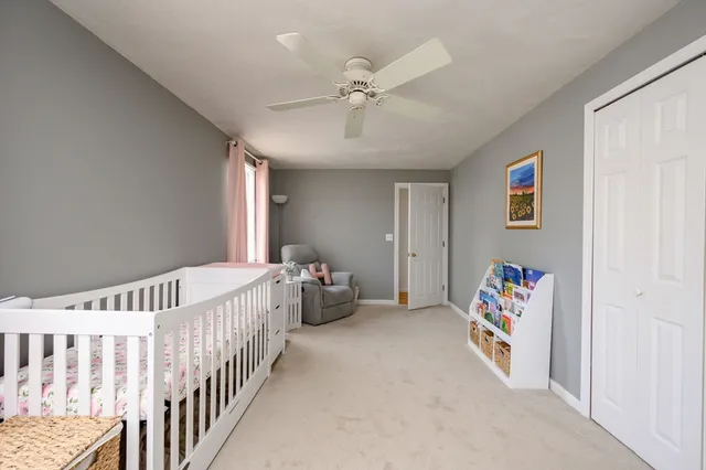 a bedroom with furniture and a chandelier fan