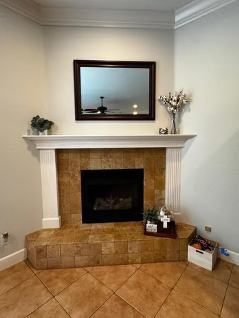 a living room with furniture a flat screen tv and a table