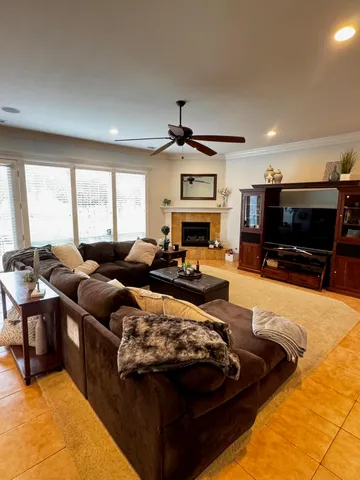 a living room with furniture ceiling fan and a rug