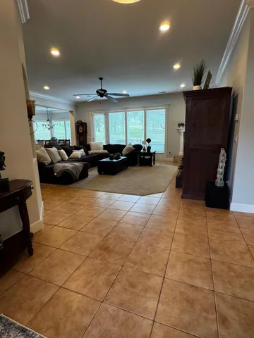 a view of a hallway with wooden floor and windows