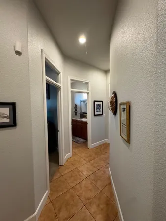a view of a hallway with wooden shelves