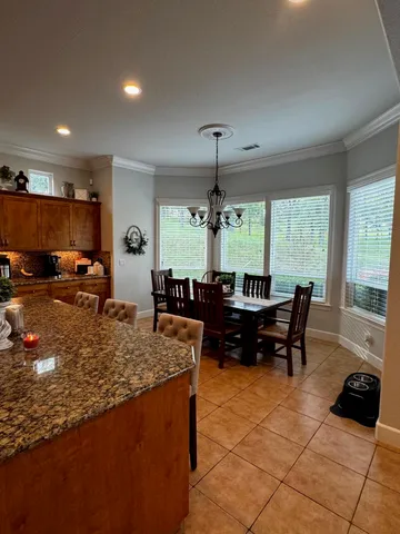 a kitchen with stainless steel appliances a sink a stove a microwave and cabinets
