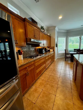 a kitchen with a sink and a stove top oven