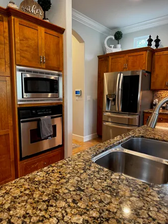 a spacious bedroom with a bed and a dresser