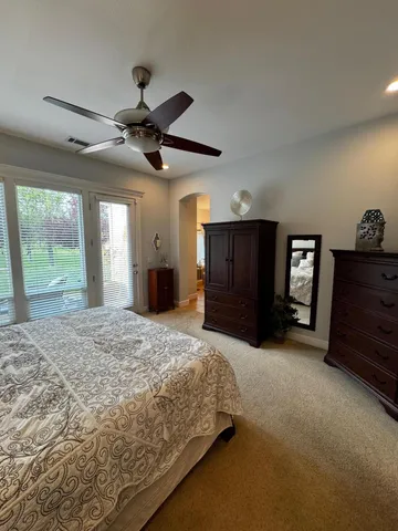 a bedroom with a large bed and a large window
