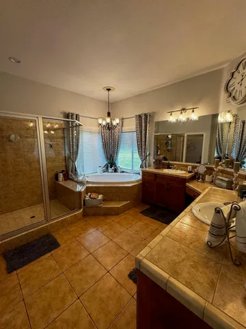 a bathroom with a tub sink and mirror
