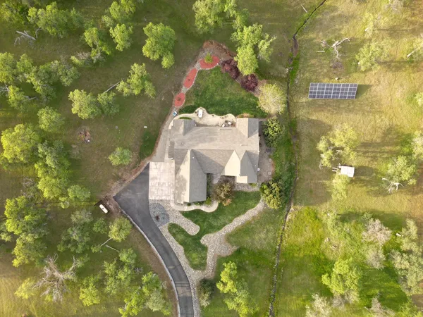 a view of a lush green hillside and houses